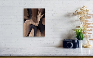 a white brick wall with a black and brown painting on it